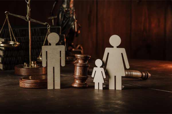 paper cutouts of family standing by gavel and scale, What To Do if Your Ex Isn't Paying Alimony in Illinois