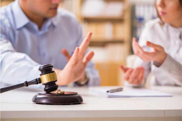 man and women talking at a table with paperwork and gavel in front of them, Do I Need a Lawyer for a Divorce in Illinois?