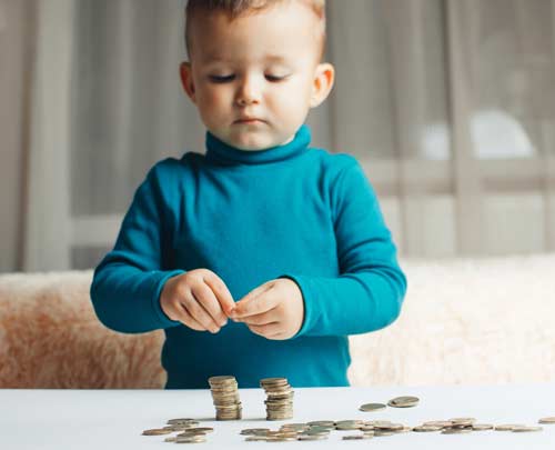 Young kid playing with coins